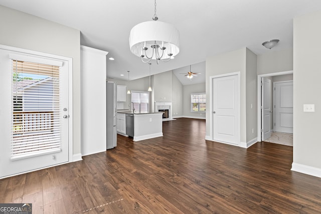 517 Lago Ct, Lagrange, GA 30241 - unfurnished living room with a sink, dark wood finished floors, baseboards, ceiling fan with notable chandelier, and a fireplace
