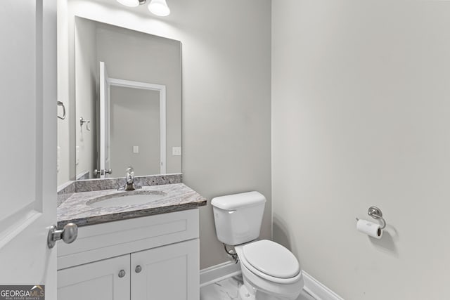 517 Lago Ct, Lagrange, GA 30241 - half bathroom with marble finish floor, toilet, vanity, and baseboards