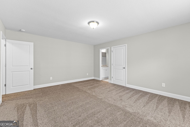 517 Lago Ct, Lagrange, GA 30241 - unfurnished bedroom featuring baseboards, carpet floors, and connected bathroom