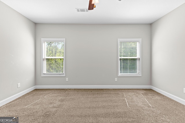 517 Lago Ct, Lagrange, GA 30241 - carpeted empty room with ceiling fan, baseboards, visible vents, and plenty of natural light