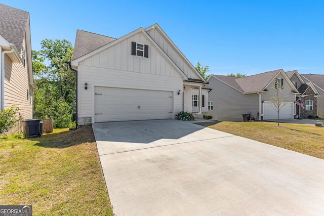 517 Lago Ct, Lagrange, GA 30241 - view of front facade featuring a front lawn, driveway, board and batten siding, cooling unit, and a garage