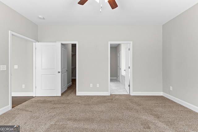 517 Lago Ct, Lagrange, GA 30241 - unfurnished bedroom featuring a walk in closet, carpet flooring, and baseboards