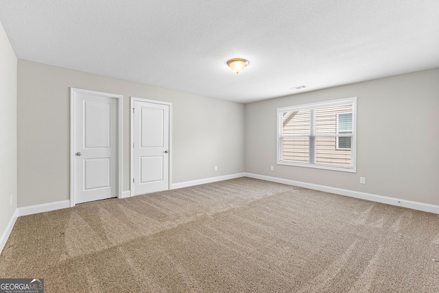 517 Lago Ct, Lagrange, GA 30241 - unfurnished bedroom featuring visible vents, baseboards, carpet flooring, and a textured ceiling