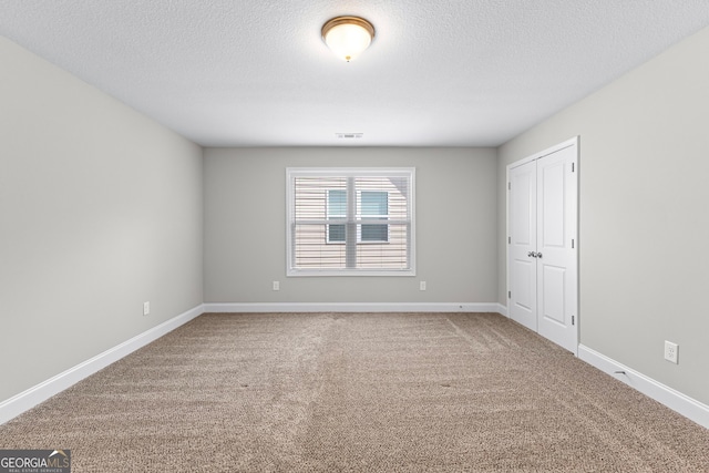 517 Lago Ct, Lagrange, GA 30241 - carpeted spare room with baseboards, visible vents, and a textured ceiling