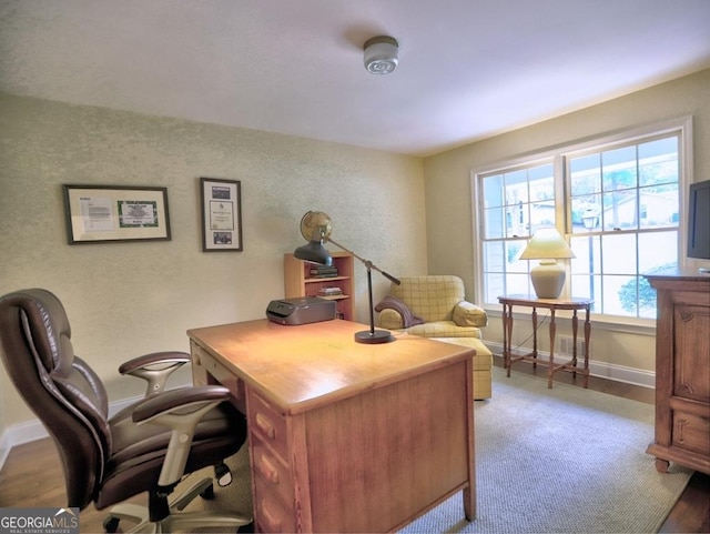 office space featuring baseboards and light wood-style flooring