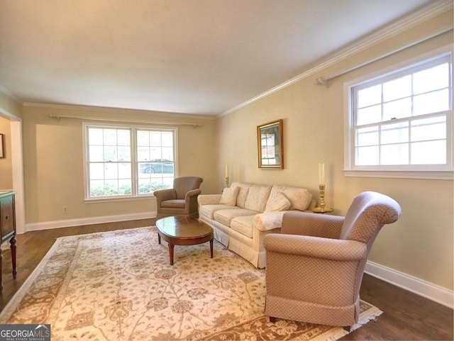 living area with crown molding, baseboards, and wood finished floors