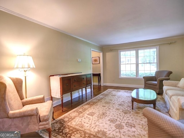 living room with baseboards, ornamental molding, and wood finished floors