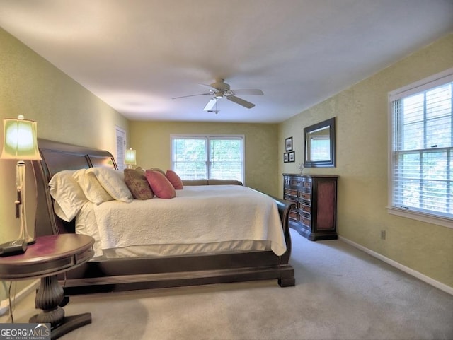 carpeted bedroom featuring baseboards and ceiling fan
