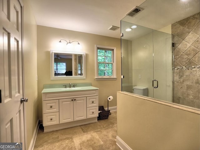 full bath featuring visible vents, baseboards, vanity, and a shower stall