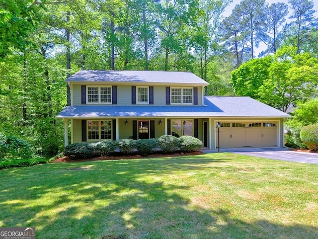 view of front of home featuring a garage, driveway, and a front lawn