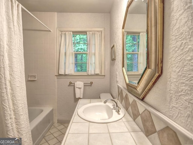 full bathroom featuring a sink, tile patterned flooring, plenty of natural light, and shower / bath combination with curtain