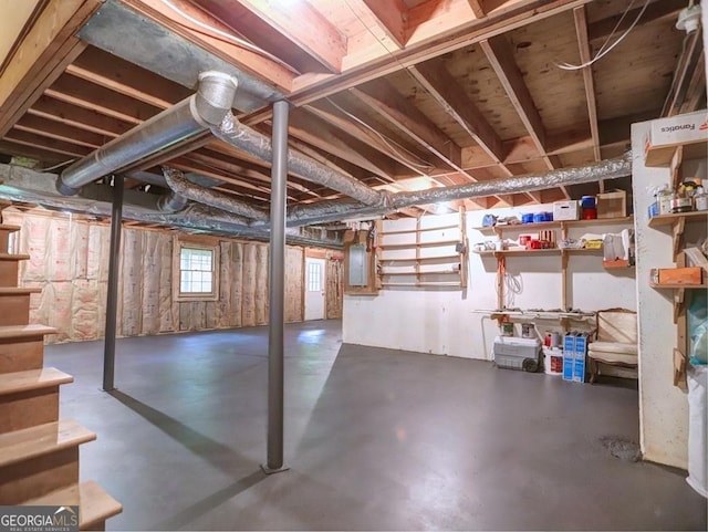 basement with stairs and electric panel