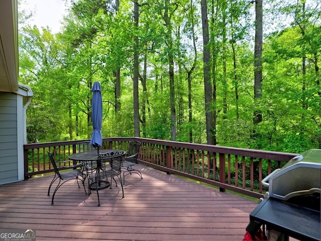 wooden deck featuring outdoor dining space