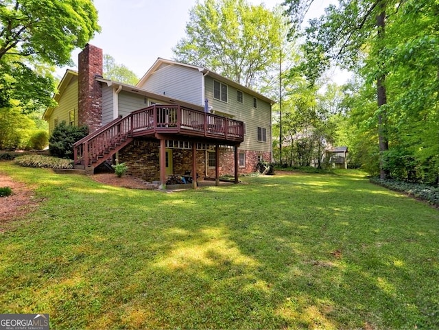 back of property featuring a chimney, a deck, stairway, brick siding, and a yard