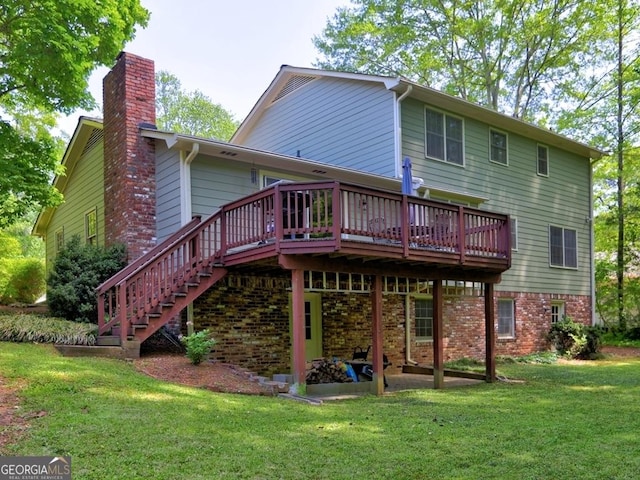 rear view of property with a wooden deck, a chimney, a yard, and stairway