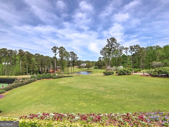surrounding community featuring a water view, golf course view, and a yard