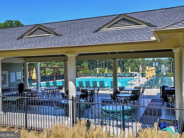 exterior space with a swimming pool and fence