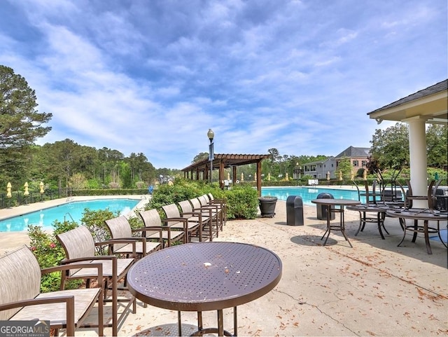 pool featuring a pergola and a patio