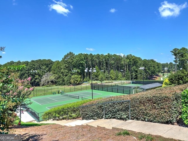 view of tennis court featuring fence