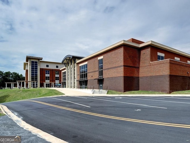 view of property featuring uncovered parking