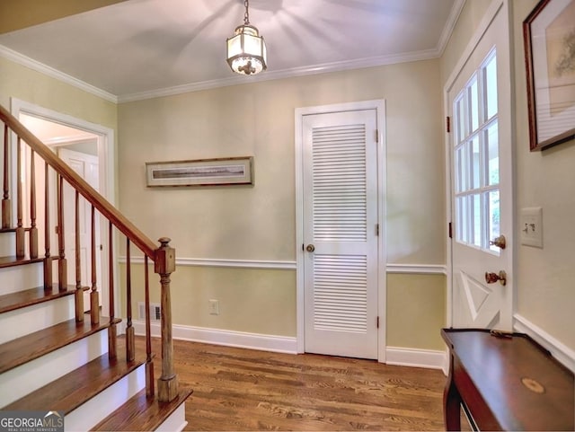 entryway featuring crown molding, dark wood finished floors, visible vents, and stairway