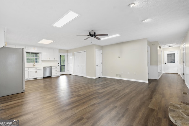 499 Old Deer Path Way, Cleveland, GA 30528 - unfurnished living room with a sink, baseboards, visible vents, a ceiling fan, and dark wood-type flooring