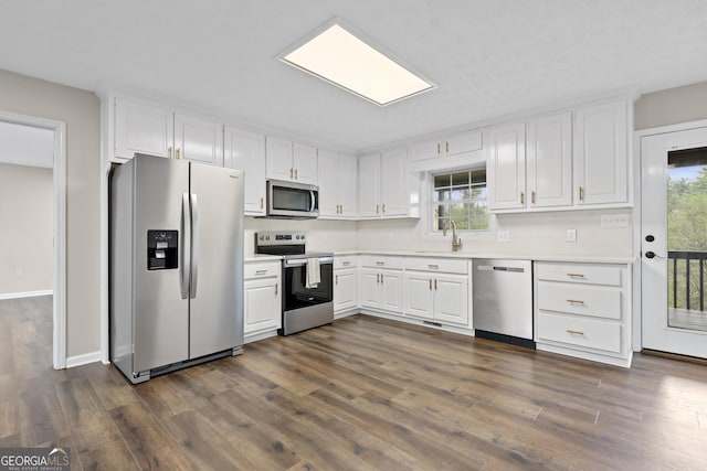 499 Old Deer Path Way, Cleveland, GA 30528 - kitchen with dark wood-style flooring, a wealth of natural light, stainless steel appliances, and white cabinetry