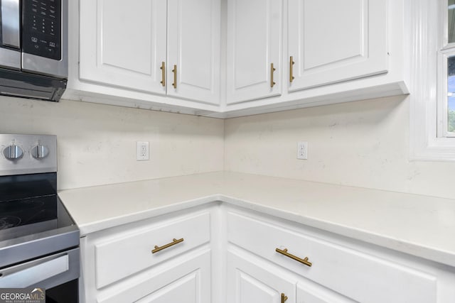 499 Old Deer Path Way, Cleveland, GA 30528 - kitchen featuring white cabinets, stainless steel appliances, and light countertops