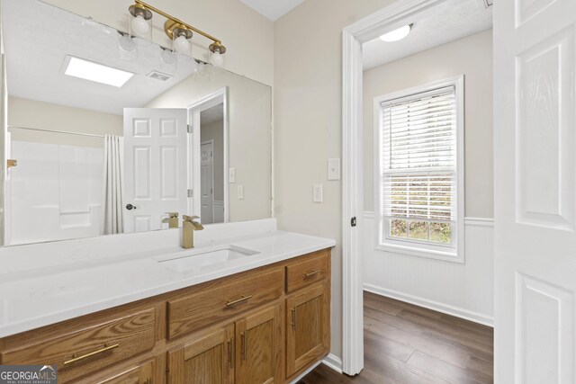 499 Old Deer Path Way, Cleveland, GA 30528 - full bathroom featuring curtained shower, visible vents, wood finished floors, vanity, and wainscoting