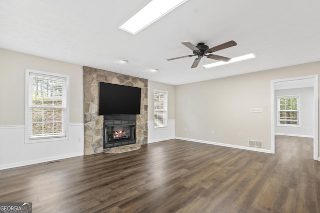499 Old Deer Path Way, Cleveland, GA 30528 - unfurnished living room featuring dark wood finished floors, visible vents, a stone fireplace, and plenty of natural light