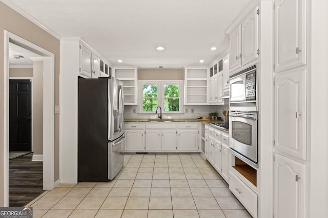 kitchen with open shelves, a sink, white cabinetry, and appliances with stainless steel finishes