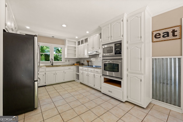 kitchen with white cabinets, appliances with stainless steel finishes, open shelves, under cabinet range hood, and light tile patterned floors