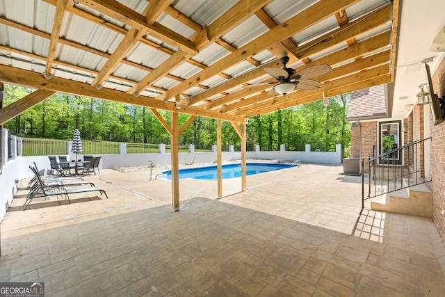 view of swimming pool with a patio area, a fenced backyard, a ceiling fan, and a fenced in pool