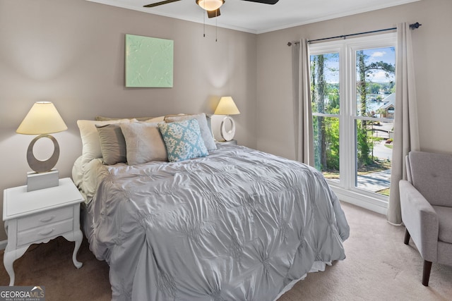 bedroom with ornamental molding, a ceiling fan, and light carpet