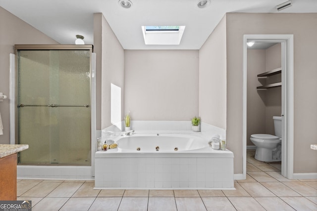 full bathroom with toilet, a skylight, tile patterned flooring, a shower stall, and a tub with jets