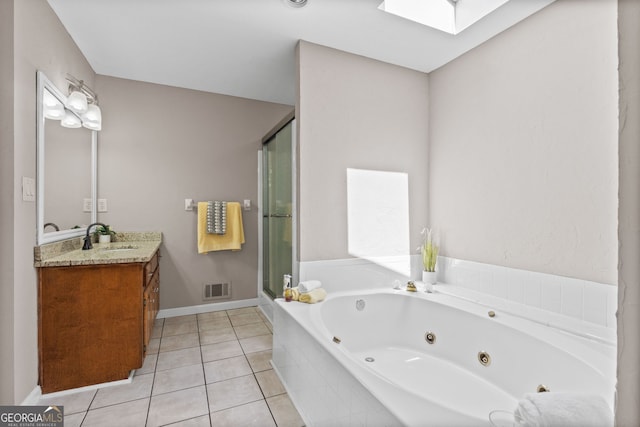 full bath with a shower stall, tile patterned flooring, visible vents, vanity, and a skylight