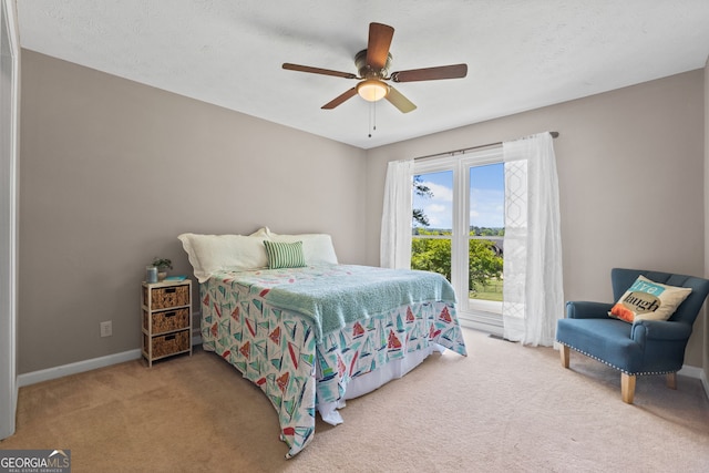 carpeted bedroom with a ceiling fan and baseboards