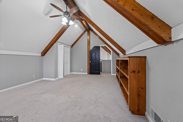 bonus room featuring a ceiling fan, light carpet, baseboards, lofted ceiling, and visible vents