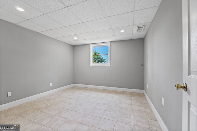 spare room with a paneled ceiling, baseboards, visible vents, recessed lighting, and light tile patterned floors
