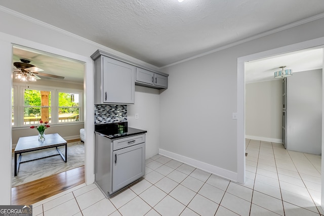 17 Spring Cir, Watkinsville, GA 30677 - kitchen with gray cabinetry, crown molding, a ceiling fan, dark countertops, and backsplash