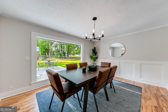 17 Spring Cir, Watkinsville, GA 30677 - dining room featuring a chandelier, light wood-style floors, crown molding, and a textured ceiling