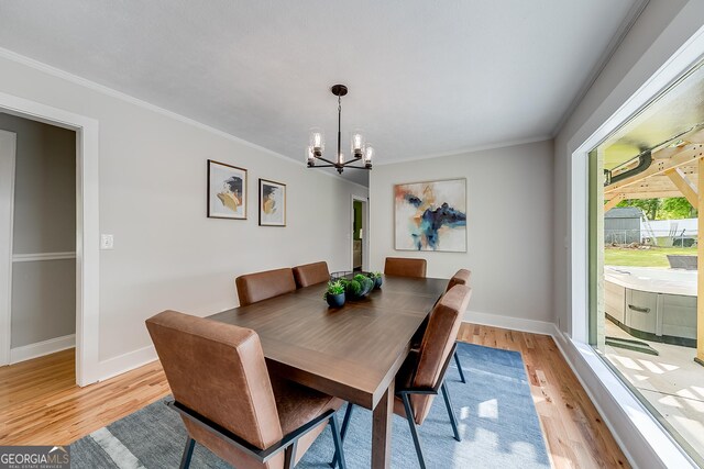 17 Spring Cir, Watkinsville, GA 30677 - dining space with a chandelier, light wood-style floors, baseboards, and crown molding