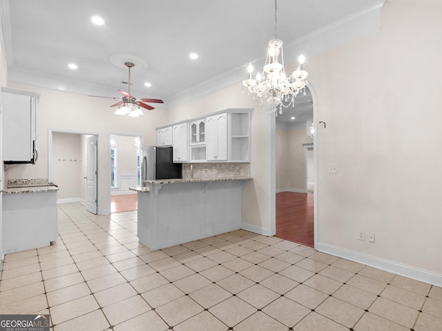 kitchen featuring freestanding refrigerator, ceiling fan, ornamental molding, white cabinetry, and open shelves