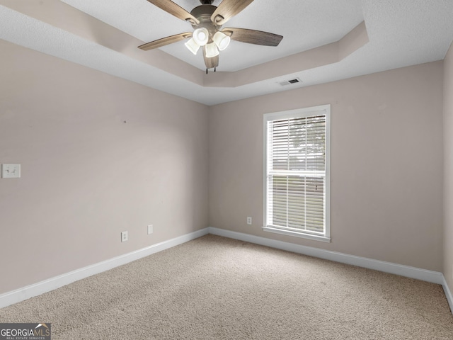 carpeted spare room with baseboards and ceiling fan