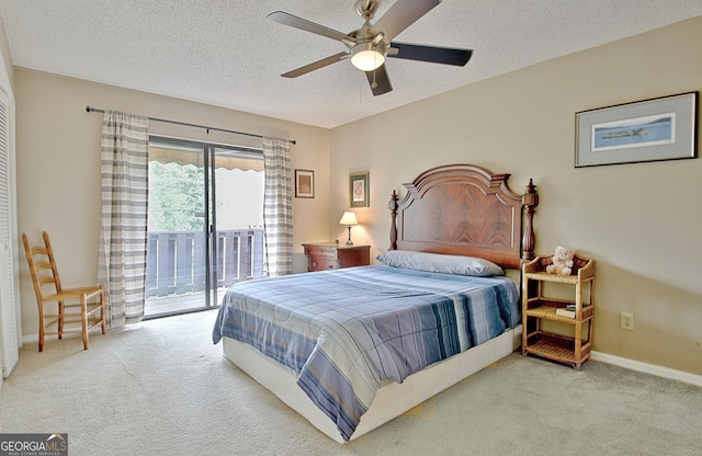 carpeted bedroom featuring a textured ceiling, access to exterior, a ceiling fan, and baseboards