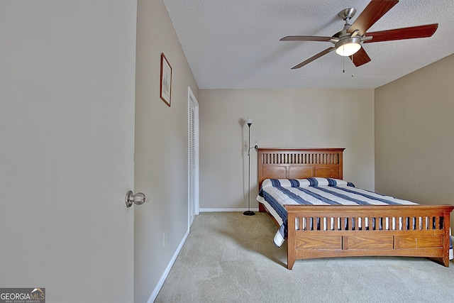 bedroom featuring carpet, a textured ceiling, baseboards, and ceiling fan