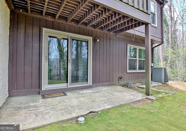 property entrance with central air condition unit and a patio