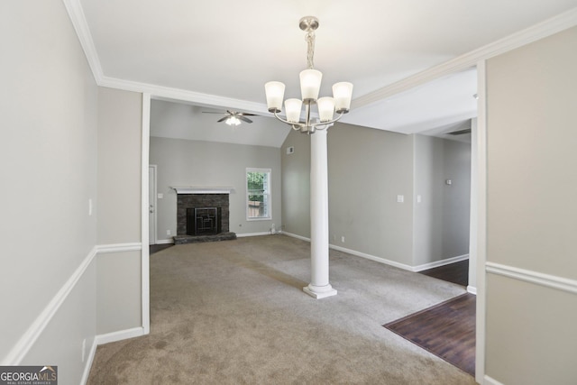 1945 Grayson Oaks Ct, Lawrenceville, GA 30045 - unfurnished living room with crown molding, a stone fireplace, carpet, ceiling fan with notable chandelier, and baseboards
