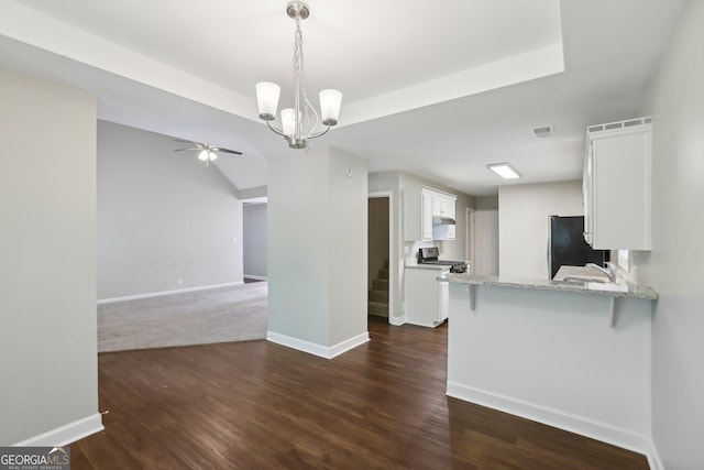 1945 Grayson Oaks Ct, Lawrenceville, GA 30045 - kitchen featuring visible vents, freestanding refrigerator, a peninsula, white cabinetry, and ceiling fan with notable chandelier