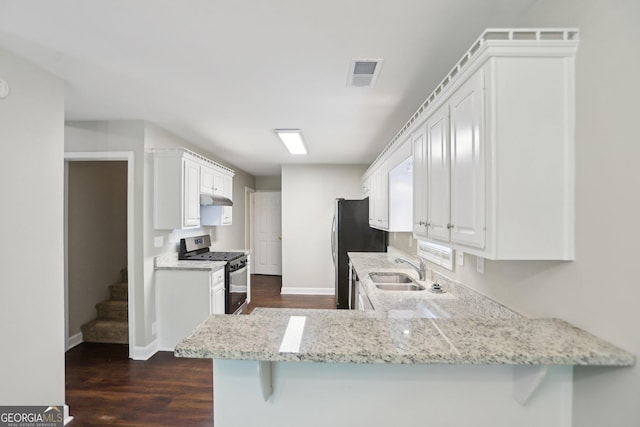 1945 Grayson Oaks Ct, Lawrenceville, GA 30045 - kitchen featuring stainless steel appliances, a sink, visible vents, and dark wood finished floors